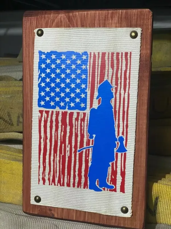 Fire Hose Sign with Firefighter and Flag